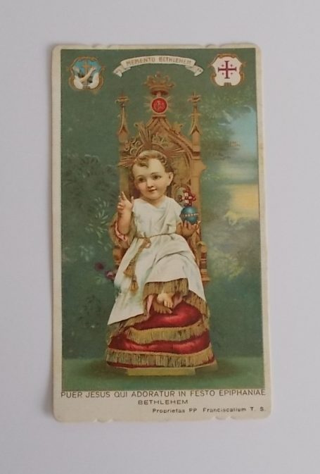 Ein Kind sitzt auf einem königlichen Thron, umgeben von dekorativem Hintergrund.